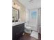 Bathroom with white subway tile and dark vanity at 2329 Outer Dr, Sarasota, FL 34231