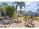 Relaxing backyard with fire pit and rocking chairs at 2329 Outer Dr, Sarasota, FL 34231