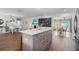 Open concept kitchen with island, white quartz countertops, and gray cabinets at 2329 Outer Dr, Sarasota, FL 34231