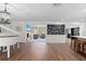 Open concept living area with hardwood floors, a fireplace, and a view into the kitchen at 2329 Outer Dr, Sarasota, FL 34231