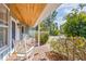 Relaxing front porch with brick flooring and white rocking chairs at 2329 Outer Dr, Sarasota, FL 34231