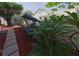 Landscaped backyard with a swing bench and privacy fence at 2566 Forest Run Ct, Clearwater, FL 33761