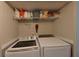 Laundry closet with washer, dryer, and storage shelves at 2566 Forest Run Ct, Clearwater, FL 33761