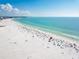 Expansive beach with people, umbrellas, and clear water at 2743 Fountain Pl, Sarasota, FL 34235