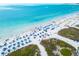 Aerial view of beach with blue umbrellas and turquoise water at 2743 Fountain Pl, Sarasota, FL 34235