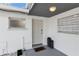 Front entrance with white door and small potted plants at 2743 Fountain Pl, Sarasota, FL 34235