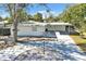 House exterior showcasing front yard landscaping and driveway at 2743 Fountain Pl, Sarasota, FL 34235