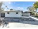 White single story home with carport and landscaped yard at 2743 Fountain Pl, Sarasota, FL 34235