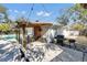 Outdoor patio with pergola, dining area, grill, and pool access at 2743 Fountain Pl, Sarasota, FL 34235