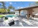 Outdoor patio with pergola, dining area, lounge furniture, and pool view at 2743 Fountain Pl, Sarasota, FL 34235