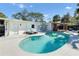 Inviting kidney shaped pool with lounge chairs and outdoor shower at 2743 Fountain Pl, Sarasota, FL 34235