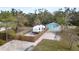 Property includes a teal house and travel trailer at 3200 Tobero Ln, Sarasota, FL 34235