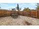 Fenced backyard with gravel and patio furniture at 3200 Tobero Ln, Sarasota, FL 34235