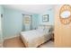 Beach-themed bedroom with a queen bed and tile floors at 3200 Tobero Ln, Sarasota, FL 34235