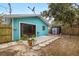 Teal house exterior with patio and shed at 3200 Tobero Ln, Sarasota, FL 34235