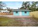 Light blue house with a fenced yard and brick patio at 3200 Tobero Ln, Sarasota, FL 34235