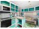 Teal and white RV interior with kitchen and living area at 3200 Tobero Ln, Sarasota, FL 34235