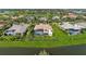 The aerial view shows a manicured lawn and screen enclosed patio highlighting the home's outdoor features at 3360 Founders Club Dr, Sarasota, FL 34240