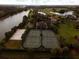 Aerial view of the community's tennis courts, basketball court, and sand volleyball court at 3360 Founders Club Dr, Sarasota, FL 34240