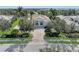 Luxury home with circular driveway, landscaping, and inviting entryway at 3360 Founders Club Dr, Sarasota, FL 34240