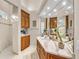 Beautiful bathroom boasting a marble countertop, wood cabinets, large mirror, and a glass-enclosed shower at 3360 Founders Club Dr, Sarasota, FL 34240