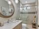 Modern bathroom featuring a vanity with a marble countertop, and a glass-enclosed shower with a built-in bench at 3360 Founders Club Dr, Sarasota, FL 34240