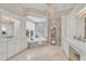 Spacious main bathroom featuring a soaking tub, tiled floors, and dual sinks at 3360 Founders Club Dr, Sarasota, FL 34240