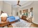 Comfortable bedroom featuring a vaulted ceiling, ceiling fan, wood floors, and three sunlit windows at 3360 Founders Club Dr, Sarasota, FL 34240