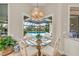 Kitchen breakfast nook with glass table and chairs overlooking the pool at 3360 Founders Club Dr, Sarasota, FL 34240