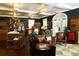 Charming clubhouse interior with leather furniture and clothing displays at 3360 Founders Club Dr, Sarasota, FL 34240