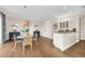 Charming dining area with a round table, wicker chairs, and hardwood floors at 3360 Founders Club Dr, Sarasota, FL 34240