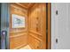 Interior view of a residential elevator featuring wood paneling, a tile floor, and integrated controls at 3360 Founders Club Dr, Sarasota, FL 34240