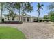 Elegant home exterior with columns, landscaping and a brick driveway at 3360 Founders Club Dr, Sarasota, FL 34240