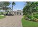 Beautiful home featuring a circular driveway, grand entrance, and meticulously manicured landscaping for enhanced curb appeal at 3360 Founders Club Dr, Sarasota, FL 34240