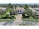 Stunning front exterior of a house showcasing the driveway, landscaping, and architectural details at 3360 Founders Club Dr, Sarasota, FL 34240