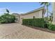 Attached garage with lush green hedge for privacy at 3360 Founders Club Dr, Sarasota, FL 34240