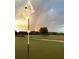 Rainbow over the golf course with a flag in the foreground at 3360 Founders Club Dr, Sarasota, FL 34240