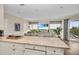 Modern kitchen with white cabinetry and granite countertops, overlooking the living area at 3360 Founders Club Dr, Sarasota, FL 34240