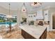 Bright kitchen featuring an island, modern lighting, stainless appliances, and breakfast nook by the pool at 3360 Founders Club Dr, Sarasota, FL 34240