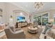 Bright living room featuring a built-in entertainment center and large windows at 3360 Founders Club Dr, Sarasota, FL 34240