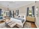 Bright main bedroom with a chandelier, bench seating, hardwood floors, and an accent rug at 3360 Founders Club Dr, Sarasota, FL 34240