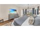 Main bedroom featuring hardwood floors, accent wall, sitting area and views of the outdoors at 3360 Founders Club Dr, Sarasota, FL 34240