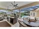 Outdoor kitchen with island and pool view at 3360 Founders Club Dr, Sarasota, FL 34240