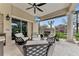 Inviting outdoor living area featuring comfortable seating, a fireplace, and a mounted television for relaxation at 3360 Founders Club Dr, Sarasota, FL 34240