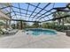 Screened pool with spa and lush landscaping, perfect for relaxation and outdoor enjoyment at 3360 Founders Club Dr, Sarasota, FL 34240