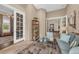 Relaxing sitting room featuring French doors, a bookshelf, and stylish decor with a view to dining room at 3360 Founders Club Dr, Sarasota, FL 34240