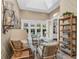 Relaxing sunroom with wicker furniture and built-in shelving at 3360 Founders Club Dr, Sarasota, FL 34240