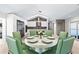 Modern dining room with round table and six sage green chairs at 3520 Wilderness W Blvd, Parrish, FL 34219