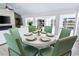 Modern dining room with round table and six sage green chairs at 3520 Wilderness W Blvd, Parrish, FL 34219