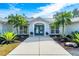 Teal double door entry flanked by tropical landscaping at 3520 Wilderness W Blvd, Parrish, FL 34219